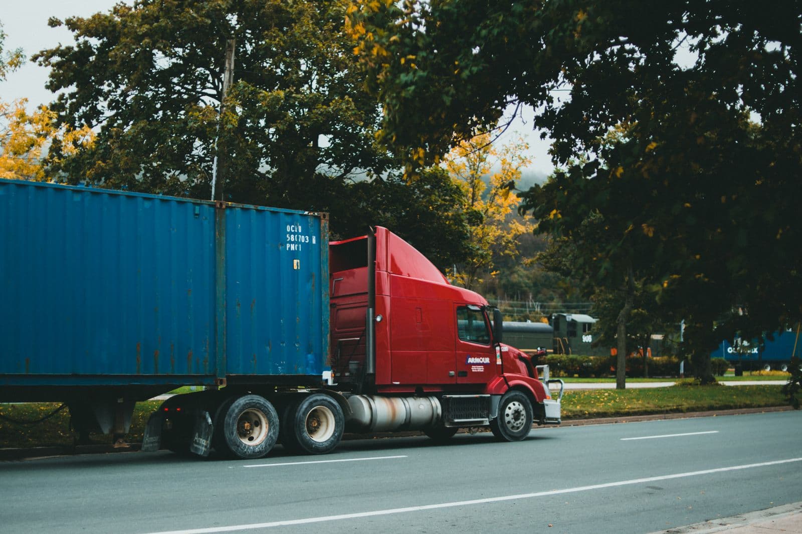 Shipping container delivered by truck across the Greater Toronto Area